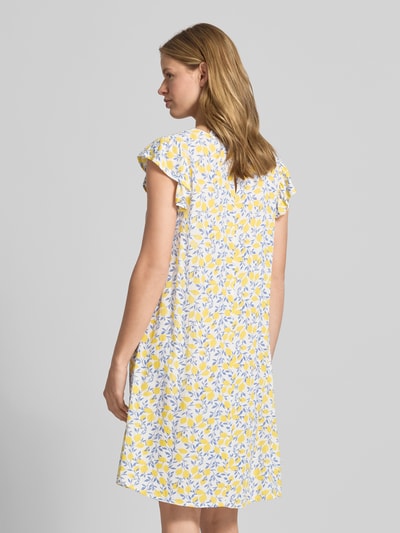 Frauenmodel trägt Regular Fit Sommerkleid aus reiner Viskose Modell 'BARRI' von Pieces, Optik:Allover-Muster, Knielang, Rundhals, Kurzarm, Schmetterlingsärmel, Materialverarbeitung: Crêpe, Farben Gelb und Weiß, Ganzkörperansicht Rückansicht.