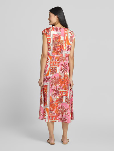 Vrouwenmodel draagt midi-jurk im allover-look met V-hals van Milano Italy, puur katoen, A-lijn, roze en oranje tinten, ruglengte maat 36: 119 cm, borstwijdte 47 cm, geheel achteraanzicht.
