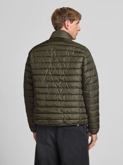 Männermodel trägt Jacke mit Label-Patch Modell 'ELVIS' von JACK & JONES in Olivgrün, gesteppte Struktur, Ganzkörperansicht Rückansicht