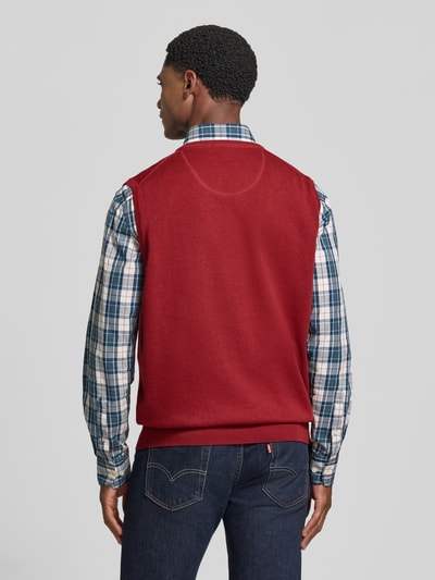 Männermodel trägt Regular Fit Pullunder aus reiner Baumwolle mit Logo-Stickerei von Fynch-Hatton in Rot, glatte Textur, Ganzkörperansicht Rückansicht.