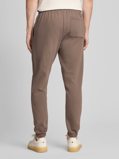Mężczyznamodel nosi Sweatpants mit Eingrifftaschen od GAP, mieszanka bawełny, krój regular fit, logo, wpuszczane kieszenie, widok całej sylwetki z tyłu