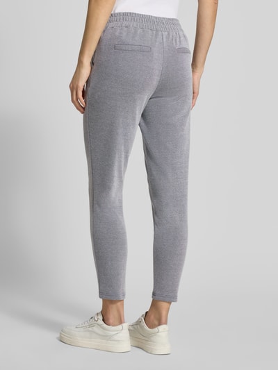 Vrouwenmodel draagt Slim Fit Stoffhose met elastische tailleband Modell 'Kate' van ICHI in grijs, katoenmix, paspelzakken, volledige achteraanzicht.
