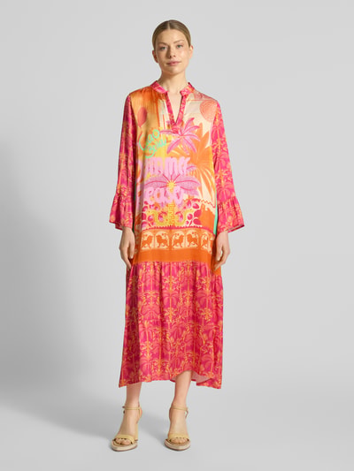 Kobiece model nosi sukienka midi z wiskozy z dekoltem w serek model 'Orange Palm' od miss goodlife, linia a, wzór na całej powierzchni, długość tyłu w rozmiarze s: 130 cm, szerokość w rozmiarze s: 53 cm, długość rękawów w rozmiarze s: 58 cm, wyraziste kolory pomarańczowy i różowy, gładka tekstura, całkowity widok z przodu