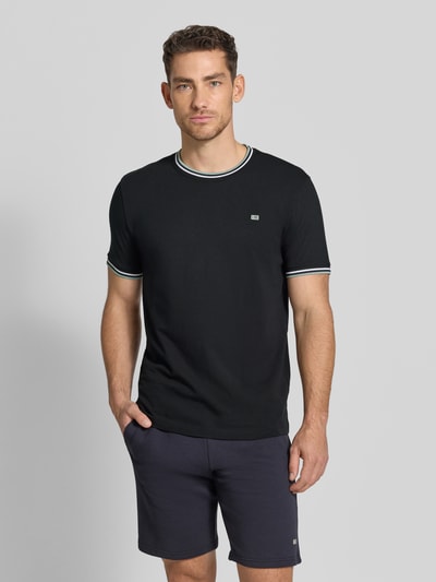 Männermodel trägt T-Shirt mit Kontraststreifen und Rundhalsausschnitt von Christian Berg Men, Baumwoll-Elasthan-Mix, Regular-Fit, Rückenlänge bei Größe M 71 cm, dunkle Farben, glatte Textur, Ganzkörperansicht von vorne.