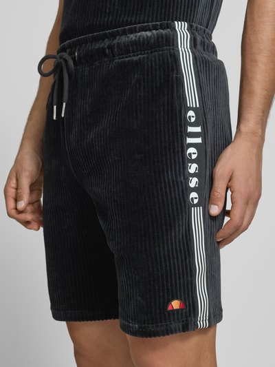 Männermodel trägt Shorts aus Cord Modell 'TOMATRO' von Ellesse, Baumwoll-Mix mit Stretch-Anteil, Regular-Fit, elastischer Bund, Tunnelzug, Nahaufnahme Oberkörper.