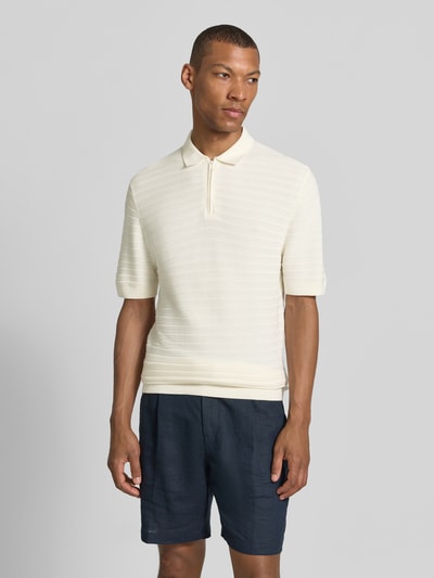 Mężczyznęmodel nosi Regular Fit Poloshirt mit kurzem Reißverschluss von MCNEAL, mieszanka bawełny i wiskozy, fakturowany wzór, kołnierzyk polo, krój regular fit, zamek błyskawiczny, kremowy, długość tyłu 69 cm, długość rękawów 26 cm, widok całej sylwetki z przodu.