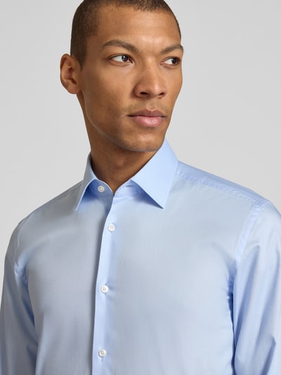Mężczyznamodel nosi Slim Fit Businesshemd aus reiner Baumwolle Modell 'HANK' von BOSS, jednokolorowy, popelina, popelina bawełniana, kołnierzyk typu kent, listwa guzikowa na całej długości, naszywka z logo, długi rękaw, sportowy mankiet, zaokrąglone wykończenie, krój slim fit, efekt: jednolity kolor, materiał: bawełna, popelina, popelina bawełniana, model: HANK, Ganzkörperansicht von vorne