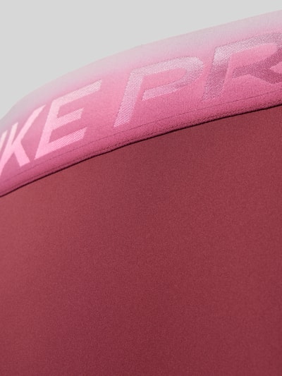Produktfoto, Slim Fit Sport-Leggings mit Logo-Print von Nike in Rot und Rosa, glatte Textur, Damen Sport-Leggings von Nike
