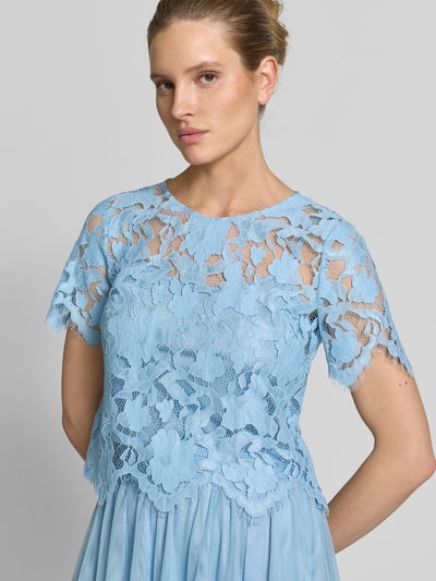Frauenmodel trägt Blusenshirt aus Spitze mit Rundhalsausschnitt von V by Vera Mont, hellblau, florale Struktur, Material-Mix, Nahaufnahme Oberkörper.