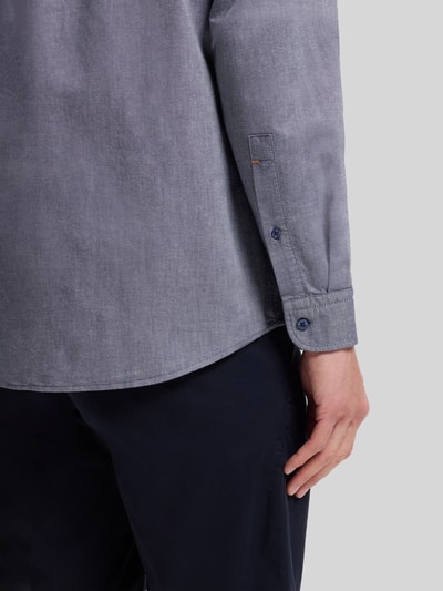 Männermodel trägt Regular Fit Freizeithemd aus Oxford-Baumwolle Modell 'RICKERT' von BOSS Orange, melierte Optik, Nahaufnahme Oberkörper.