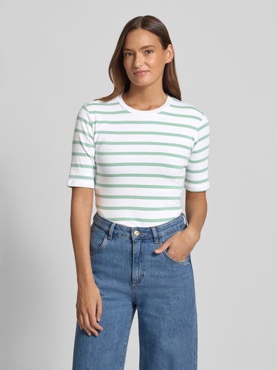 Frauenmodel trägt Basic T-Shirt Ringel O-Neck von Christian Berg Woman in Weiß mit grünen Streifen, körpernaher Schnitt, Nahaufnahme Oberkörper.