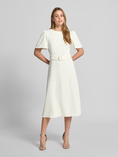 Frauenmodel trägt Cocktailkleid mit Gürtel und Rundhalsausschnitt von Rinascimento, weiß, Material-Mix mit Stretch-Anteil, taillierter Schnitt, Midikleid, rückseitiger Reißverschluss, Rückenlänge 36 cm, Brustweite 40 cm, Ärmellänge 28 cm, Ganzkörperansicht von vorne.