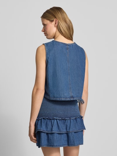 Frauenmodel trägt Relaxed Fit Denim Blusentop aus reiner Baumwolle von Tommy Jeans in blauer Denim-Optik mit Tunnelzug, Rückenansicht.