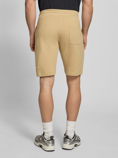 Mannenmodel draagt Straight Fit Shorts met logo-stitching model 'Fillip' van Blend, beige, katoen, structuurpatroon, achterzak, elastische tailleband, achteraanzicht, volledige lichaamsopname.