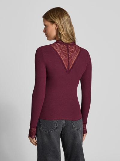 Frauenmodel trägt Slim Fit Langarmshirt aus Viskose-Mix Modell 'TILDE' von ONLY in Dunkelrot mit Spitzendetails, Damen Langarmshirt, Ganzkörperansicht Rückansicht.