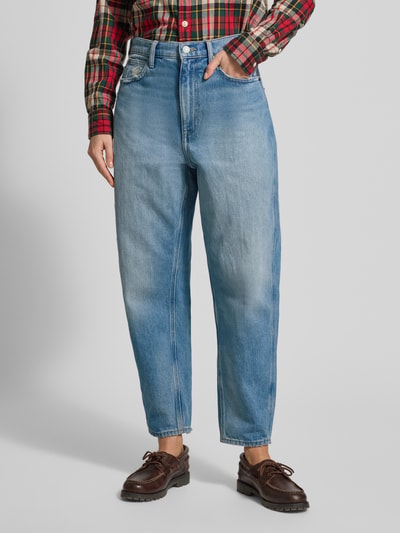 Frauenmodel trägt Jeans mit 5-Pocket-Design von Polo Ralph Lauren aus reiner Baumwolle im Used-Look, lockerer Schnitt, helle Blautöne, Knopf- und Reißverschluss, Ganzkörperansicht von vorne.