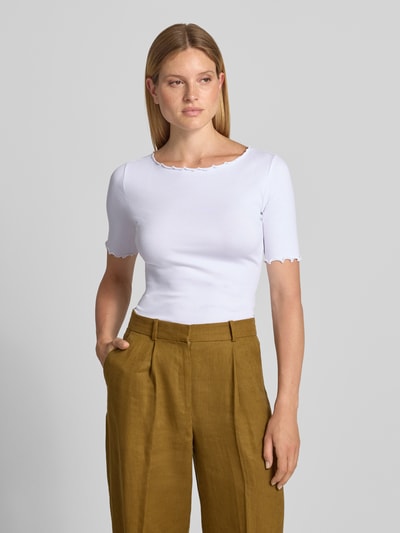 Kobiece model prezentuje T-shirt mit Rundhalsausschnitt und Muschelsaum od zero, Mieszanka bawełny z dodatkiem streczu, dopasowany krój, drobne prążkowanie, okrągły dekolt z falistym wykończeniem, długość tyłu w rozmiarze 36: 51 cm, jasny kolor, gładka faktura, Ganzkörperansicht von vorne.
