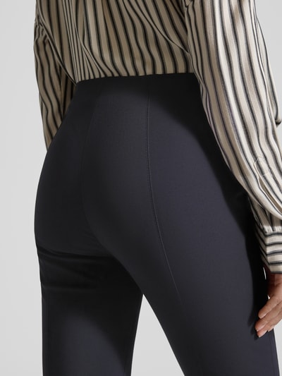 Männermodel trägt Schmale Schlupfhose aus Techno Cotton Superstretch von Raffaello Rossi, krój slim fit, model 'PENNY 6/8', szerokość w rozmiarze 36: 36 cm, długość nogawki wewnętrznej: 61 cm, granatowy kolor, gładka faktura, detailaufnahme Rückansicht.