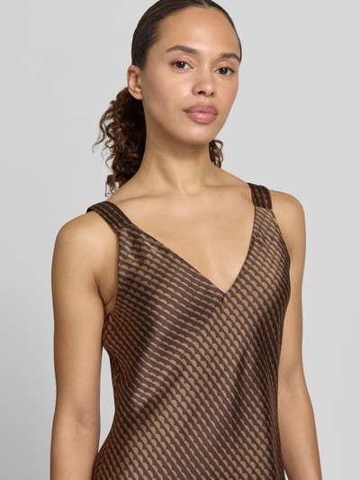 Frauenmodel trägt Damen Midikleid mit V-Ausschnitt aus braunem Satin und Wellenmuster, Modell 'Qova wave' von Someday, Nahaufnahme Oberkörper, Kontext: Straight Fit, Rückseitiger V-Ausschnitt, Rückenlänge bei Größe 36: 111 cm, Brustweite bei Größe 36: 45 cm.
