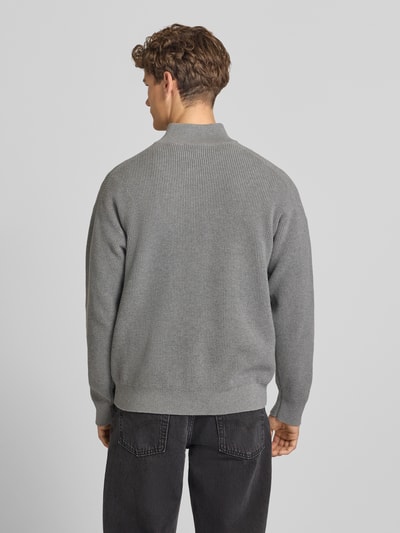 Männermodel trägt Loose Fit Troyer mit gerippten Abschlüssen von Calvin Klein Jeans in Grau, Ganzkörperansicht Rückansicht.