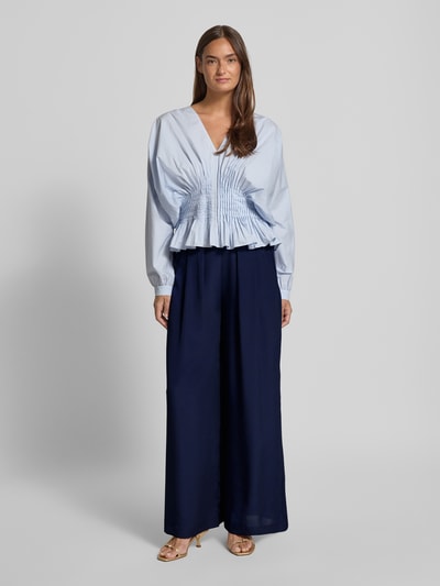 Frauenmodel trägt Wide Leg Hose mit elastischem Bund von Rich & Royal in Dunkelblau, Gelegte Falten, Eingrifftaschen, Ganzkörperansicht von vorne.