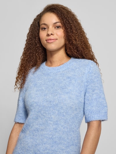 Vrouwenmodel draagt Regular fit gebreide pullover met wol, Model 'STARLA' van ONLY, mêlee look, korte mouw, ronde hals, materiaalmix, nahaufnahme bovenlichaam.