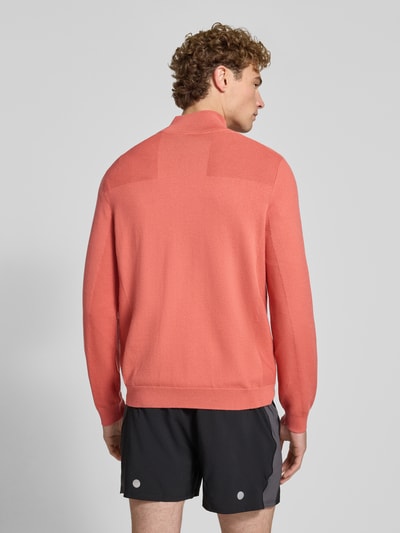Männermodel trägt Regular Fit Pullover mit Schurwoll-Anteil Modell 'KN_Momentum-X QZ' von BOSS für BOSS Green in Koralle, Ganzkörperansicht Rückansicht.