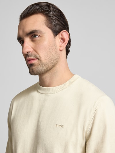 Männermodel trägt Regular Fit Strickpullover aus reiner Baumwolle Modell 'UPCAS' von BOSS, Optik: unifarben, Nahaufnahme Oberkörper.