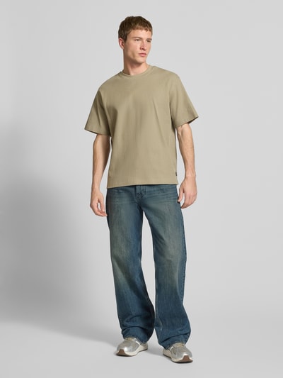 Männermodel trägt T-Shirt mit Ripp-Optik Modell 'HARRISON' von JACK & JONES, Reine Baumwolle, lockere Passform, Ganzkörperansicht von vorne.