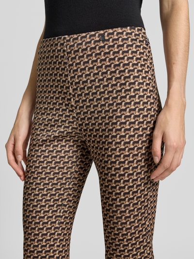 Frauenmodel trägt Flared Cut Hose im Allover-Look mit elastischem Bund von Marc Cain, braun-beiges Muster, Nahaufnahme Oberkörper, Material-Mix mit Stretch-Anteil
