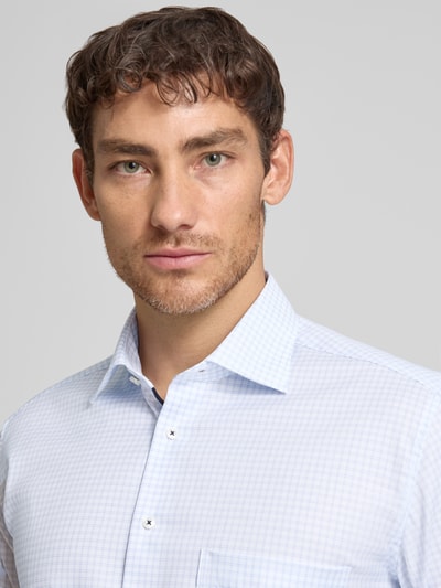Mannelijk model draagt Comfort Fit Business-Hemd aus Baumwolle mit Kentkragen van ETERNA, fijn lichtblauw ruitpatroon, puur katoen, kentkraag, borstzak, ruglengte maat 40: 80 cm, schouderbreedte maat 40: 48 cm, mouwlengte maat 40: 65 cm. Nahaufnahme bovenlichaam.