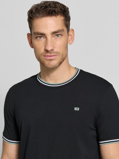 Männermodel trägt T-Shirt mit Kontraststreifen und Rundhalsausschnitt von Christian Berg Men aus Baumwoll-Elasthan-Mix, Regular-Fit, Nahaufnahme Oberkörper. Rückenlänge bei Größe M: 71 cm.
