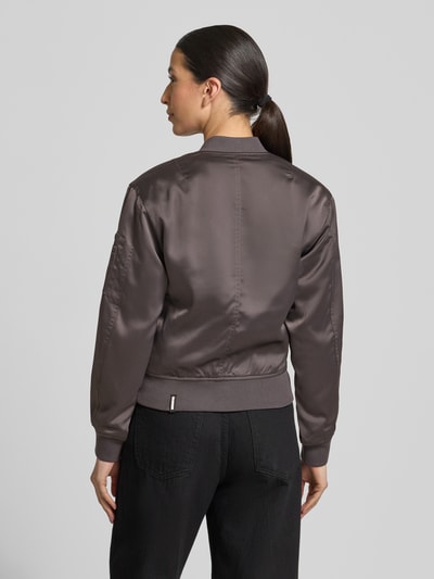 Modelka nosi Regular Fit Bomberjacke mit Stehkragen Modell 'Beth' od khujo, gładki materiał, ciemny brąz, elastyczne mankiety, widok całej sylwetki z tyłu