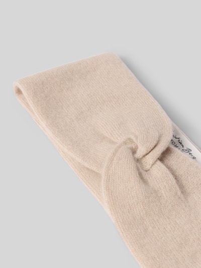 Produktfoto, hellbeiges Stirnband aus reinem Kaschmir von Christian Berg Woman, breites Design, Strick-Optik, Knotendetail.