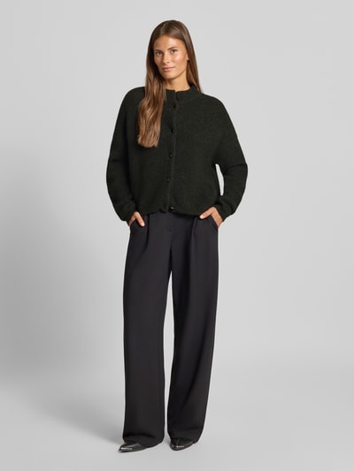 Frauenmodel trägt Regular Fit Cardigan aus Woll-Alpaka-Mix Modell 'Alpha' von Gestuz, Strick-Optik in Dunkelgrün, Ganzkörperansicht von vorne.