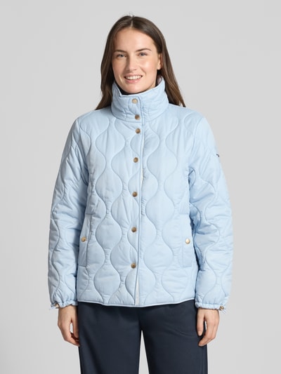 Frauenmodel trägt Regular Fit Steppjacke mit gefüttertem Stehkragen von Christian Berg Woman Selection, hellblau, Stepp-Optik, Eingrifftaschen, Knopfleiste, Ganzkörperansicht von vorne.
