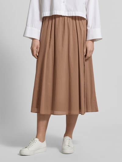 Frauenmodel trägt Midirock mit elastischem Logo-Bund von JOOP! aus reiner Baumwolle in A-Linie, Label-Detail, Nahaufnahme Unterkörper.