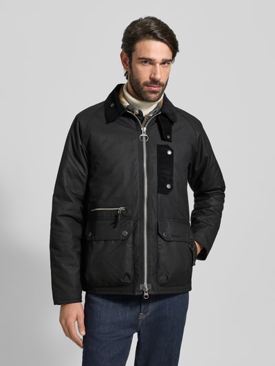Männermodel trägt Regular Fit Wachsjacke aus reiner Baumwolle von Barbour, Optik: Unifarben, Applikation: Label-Stitching, Ganzkörperansicht von vorne.