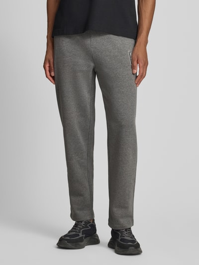 Männermodel trägt Sweatpants mit elastischem Bund und Logo von GAP in Grau, Regular Fit, Baumwoll-Mix, Ganzkörperansicht von vorne.
