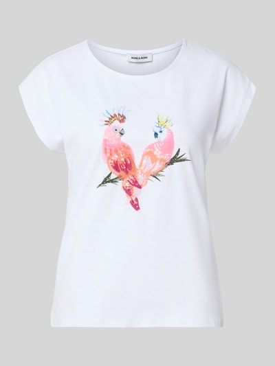 Frauenmodel trägt T-Shirt mit Motiv-Print und Pailletten von MORE & MORE aus Baumwoll-Elasthan-Mix, Regular-Fit, Rundhalsausschnitt, weiß, Rückenlänge bei Größe 36: 57 cm, Ganzkörperansicht von vorne.