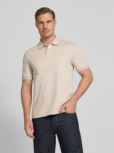 Männermodel trägt Regular Fit Poloshirt aus reiner Baumwolle Modell 'INTERLOCK' von BOSS Orange in Beige, unifarben, Nahaufnahme Oberkörper.