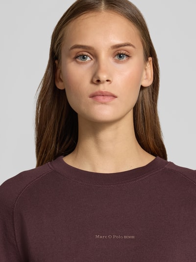 Frauenmodel trägt Regular Fit Sweatshirt aus reiner Baumwolle von Marc O'Polo DENIM in Dunkelviolett, feine Textur, Nahaufnahme Oberkörper.