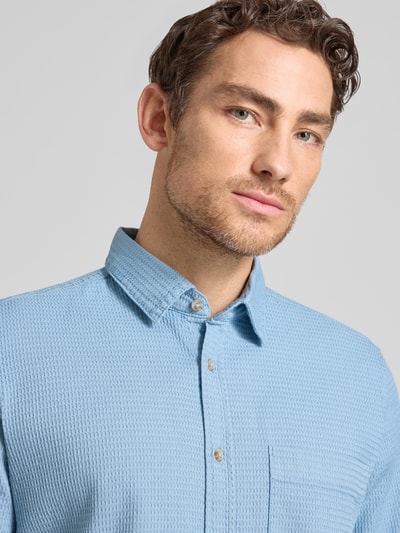 Männermodel trägt Regular Fit Freizeithemd aus reiner Baumwolle von Tom Tailor in Optik: Unifarben mit Struktur, Kentkragen, Brusttasche, Nahaufnahme Oberkörper.