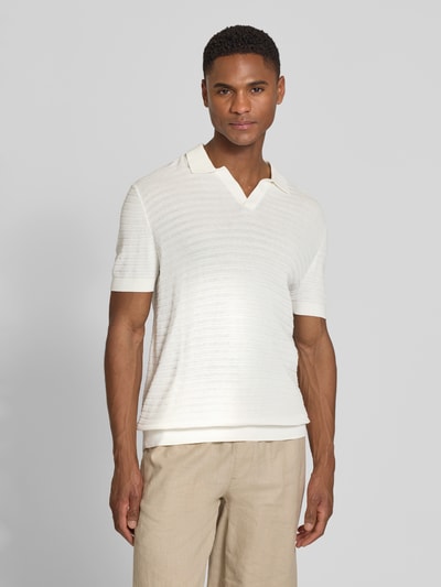 Männermodel trägt Slim Fit Strick-Poloshirt mit Strukturmuster Modell 'BRAIAN' von Drykorn in Reine Baumwolle, V-Ausschnitt, creme, Ganzkörperansicht von vorne. Rückenlänge bei Größe M: 71 cm.