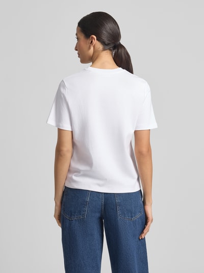 Frauenmodel trägt Basic T-Shirt mit Rundhalsausschnitt von Christian Berg Woman, unifarben, reine Baumwolle, Ganzkörperansicht Rückansicht.