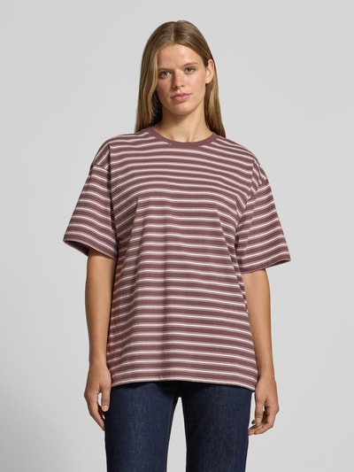 Frauenmodel trägt T-Shirt von REVIEW aus reiner Baumwolle in Braun mit weißen Streifen, lockerer Schnitt, Ganzkörperansicht von vorne.