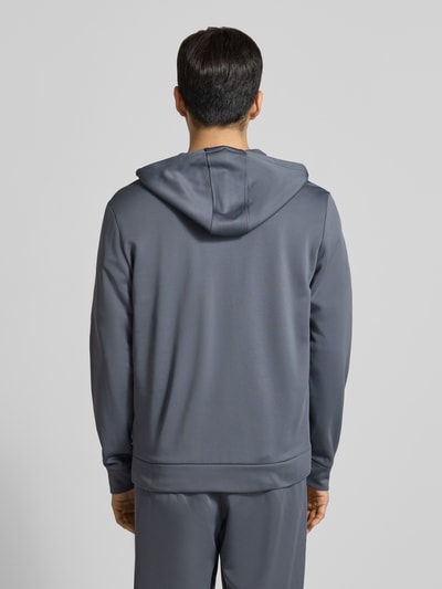 Männermodel trägt Sweatjacke mit Kapuze von Under Armour in Grau mit Lockerer-Schnitt, Kapuze, Tunnelzug, Reißverschluss, Rückenansicht.