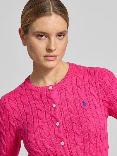 Frauenmodel trägt Slim Fit Strickjacke mit Logo-Stitching von Polo Ralph Lauren in Pink, reine Baumwolle, Rundhalsausschnitt, Nahaufnahme Oberkörper.