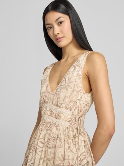 Vrouwenmodel draagt Blusentop mit V-Ausschnitt und Spitzenbesatz van Jake*s Collection in allover-look, regular fit, lichte beige tinten, zijdeachtige textuur, zijdelingse vetersluiting, ruglengte bij maat 38: 43 cm. Nahaufnahme bovenlichaam