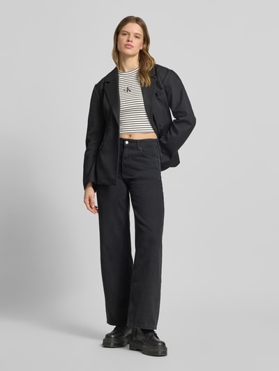 Kobiece modelka nosi Cropped T-Shirt mit Streifenmuster und Logo von Calvin Klein Jeans, mieszanka bawełny i elastanu, krój krótki, wzór w paski, logo, okrągły dekolt, długość tyłu w rozmiarze S: 39 cm, widok całej sylwetki z przodu.